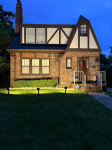 Residential landscape lighting installation illuminating a house by Harris Boys Electrical Services in Flint, MI