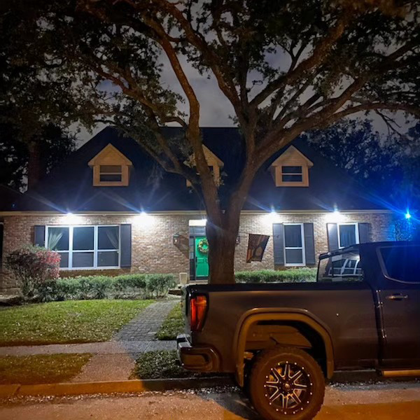 A residential lighting solution illuminating the front of a house, provided by Light of the World Electric in Lake City, FL.