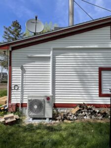 Residential LG mini-split HVAC condenser unit installed outside a home by ALC Universal in Sheridan, WY.