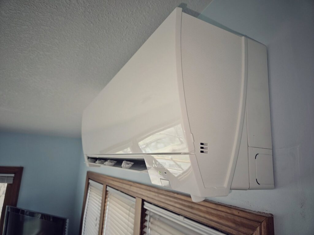 A residential indoor mini-split HVAC unit installed on a wall by Cool y Caliente HVAC Services in Bonner Springs, KS.