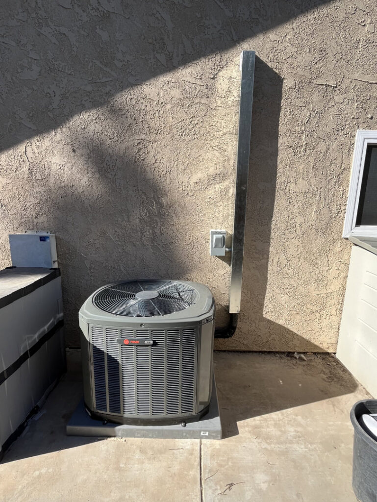 A residential outdoor AC condenser unit installed by 20th Century Heating and Air in Anaheim, CA.
