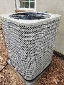 A residential outdoor AC unit installed next to a house by Allwaysthere Heating and Cooling in Frederick, MD