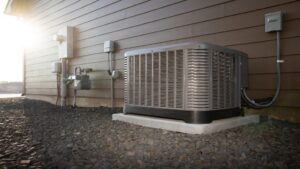 A residential outdoor air conditioning unit installed beside a house by Astron Services LLC in Wichita, KS.