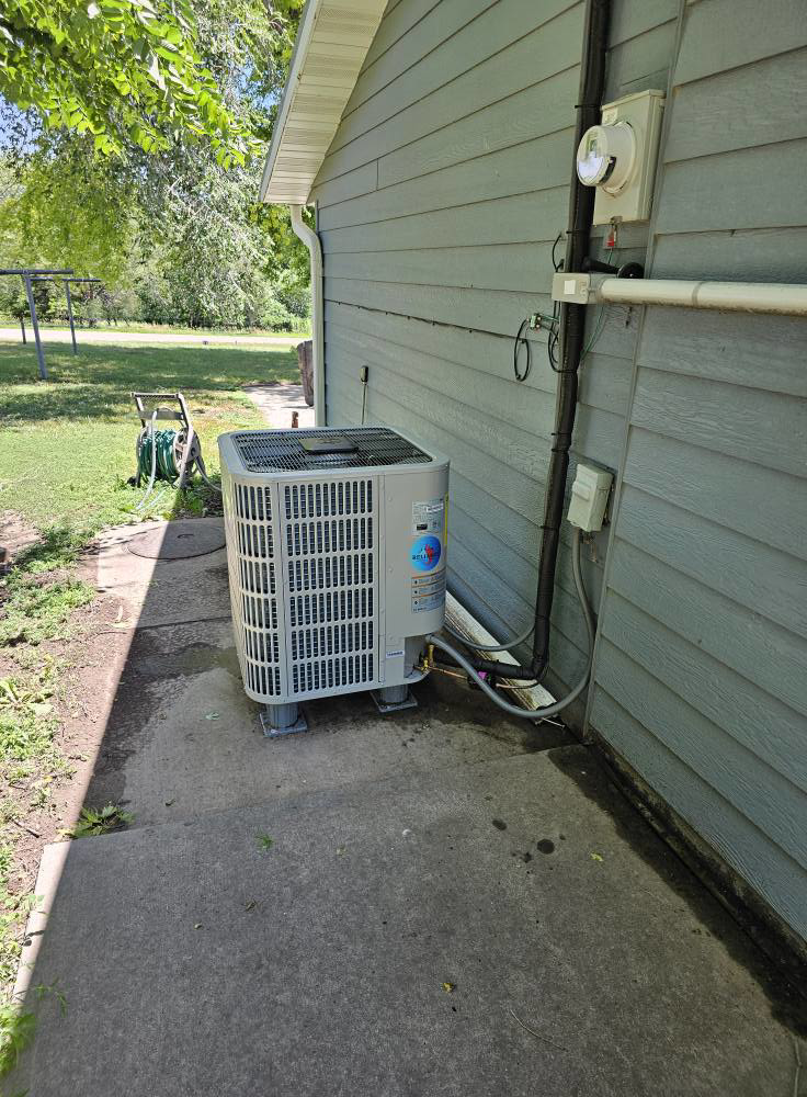 A residential outdoor AC unit installation by Reliance Heating & Cooling in Yankton, SD.