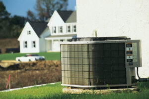 A residential outdoor air conditioning unit in a grassy area, representing services by Mid-City HVAC, INC. in Chicago, IL.