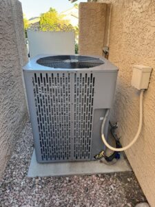 A residential outdoor air conditioning condenser unit serviced by Rogue Mechanical in Las Vegas, NV.