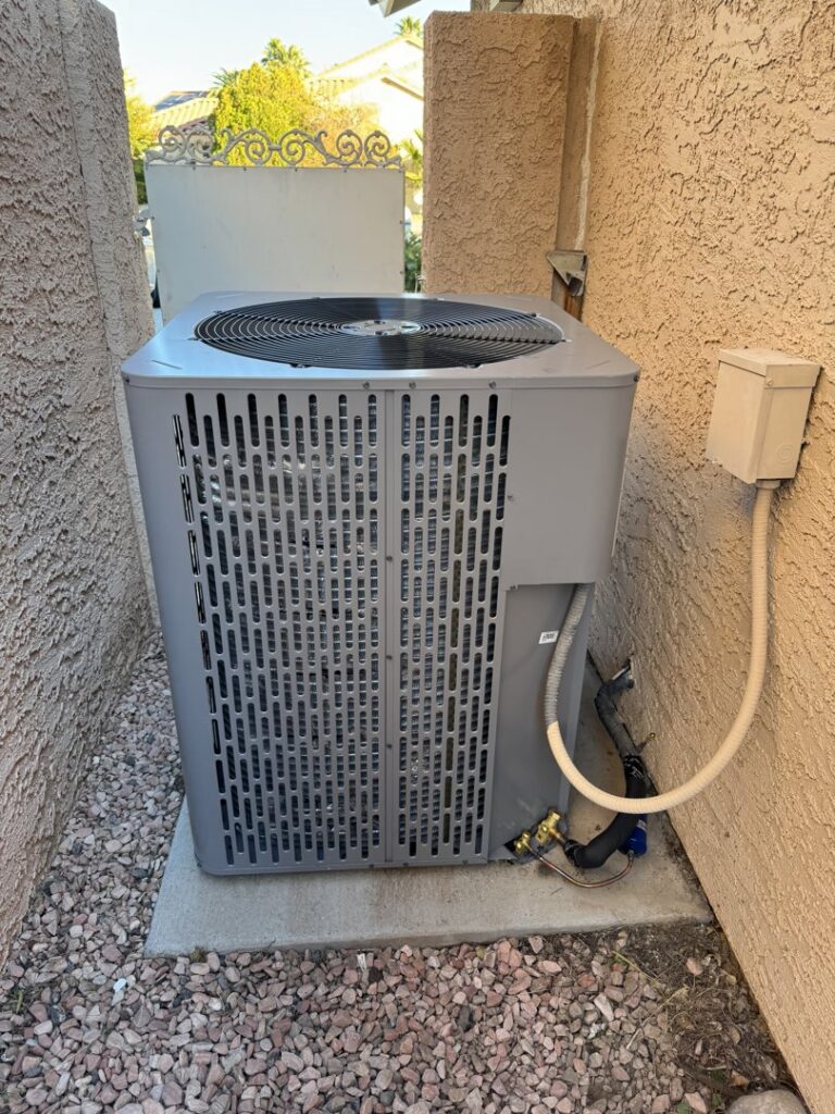 A residential outdoor air conditioning condenser unit serviced by Rogue Mechanical in Las Vegas, NV.