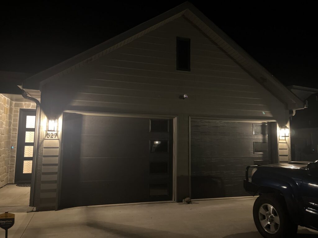 Residential outdoor lighting illuminating a home's exterior at night, installed by Midway Electric in Columbia, MO