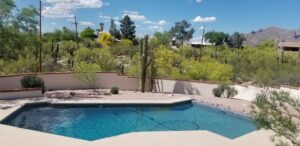 Residential pool cleaning with a hose by Up Keep Pool & Spas, ensuring clear water in Tucson, AZ.