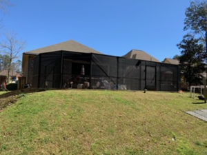 A residential pool enclosure installed by Backyard Paradise, enhancing a home in Mobile, AL.
