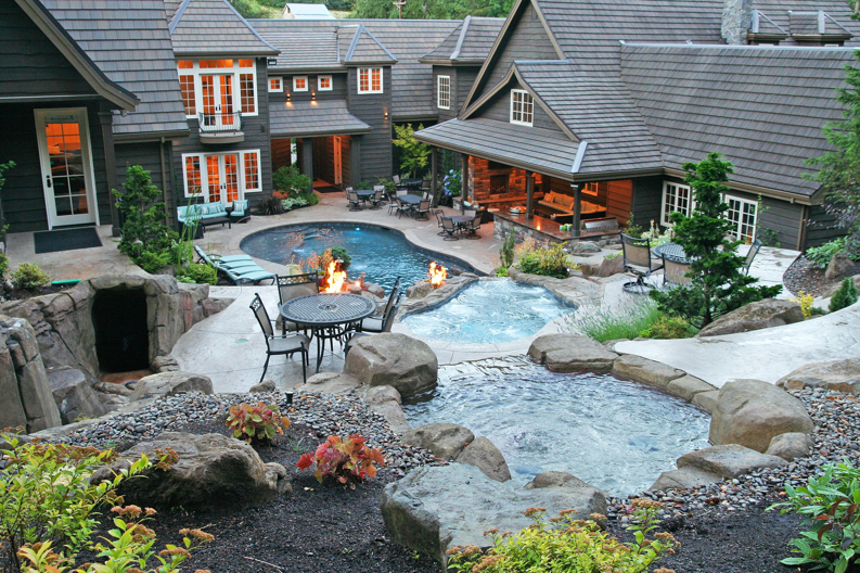 An aerial view of a residential property featuring multiple custom pools and a spa by Anderson Poolworks in Wilsonville, OR.
