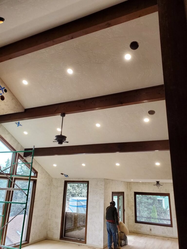 A residential room featuring new recessed lighting and a ceiling fan installed by Johnsen Electric Inc in Springfield, OR.