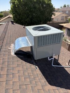 A residential rooftop HVAC package unit with ductwork installed on a shingle roof by State 48 Home Comfort LLC in Peoria, AZ.