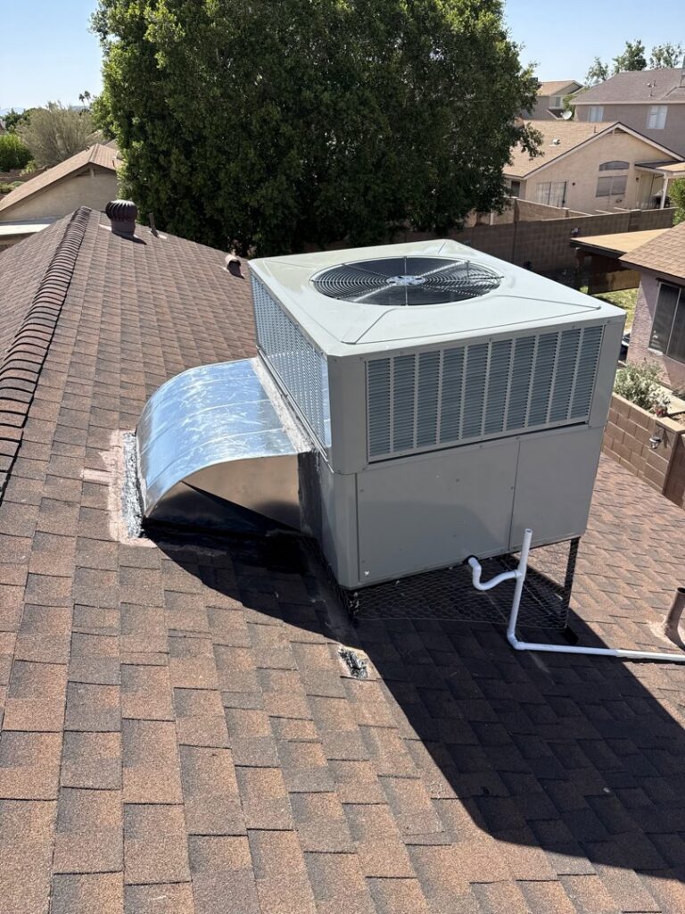 A residential rooftop HVAC package unit with ductwork installed on a shingle roof by State 48 Home Comfort LLC in Peoria, AZ.