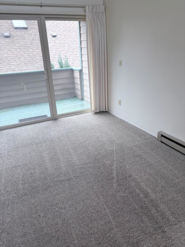 A residential room featuring a clean, light grey carpet after service by Hillsboro Carpet Cleaning in Hillsboro, OR.