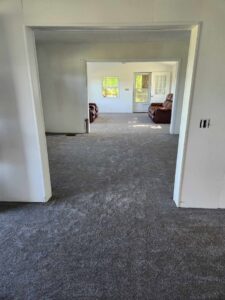 A residential room with newly installed grey carpet by PerfectStep Flooring Solutions in Rochester, NY.