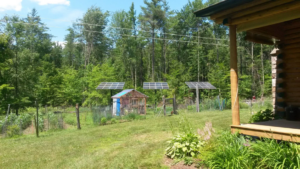 Residential solar panel installation by Metruk's Electrical Contracting, Inc. next to a home in Underhill, VT.