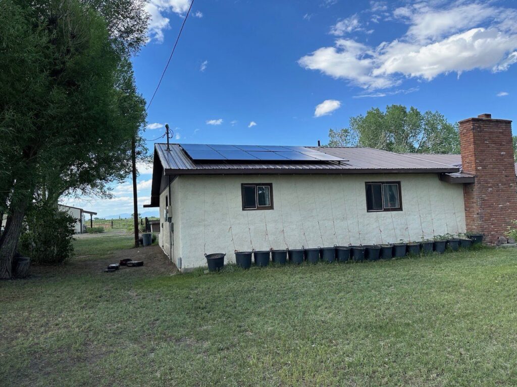 Solar panels installed on the roof of a residential home in a rural setting by Pueblo Electrics, Inc. in Pueblo, CO.