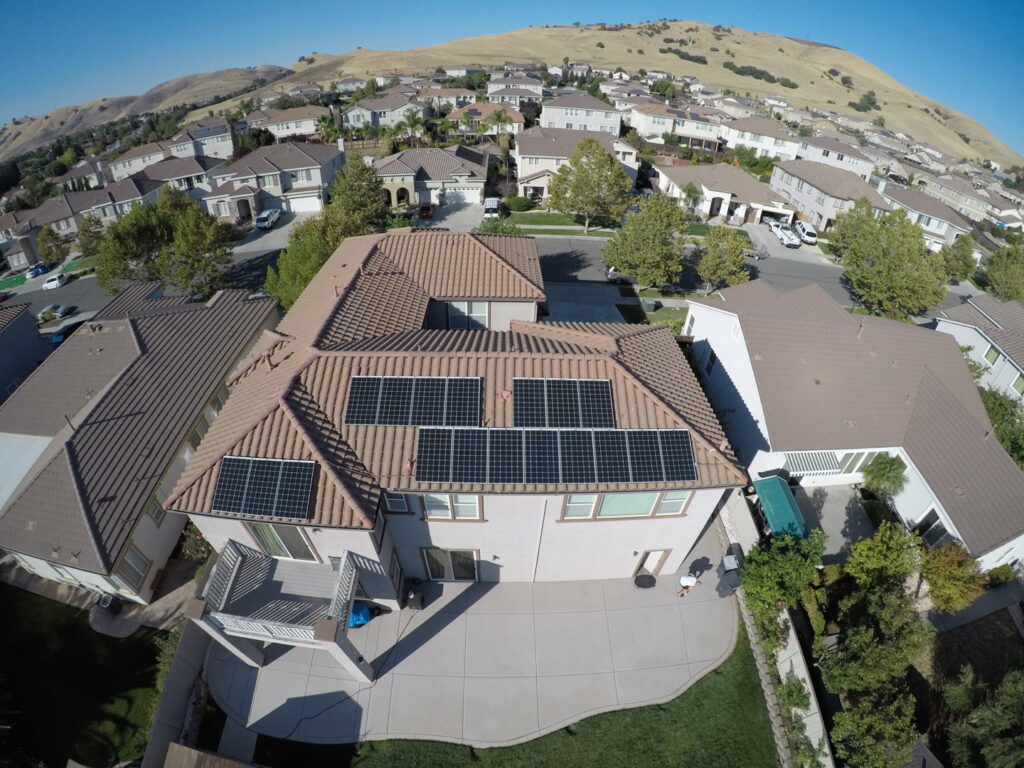 An aerial view of a residential home with newly installed solar panels by Solar & Electric Service Bros in West Sacramento, CA.
