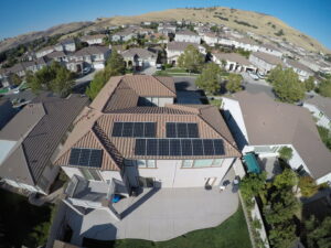 An aerial view of a residential home with newly installed solar panels by Solar & Electric Service Bros in West Sacramento, CA.