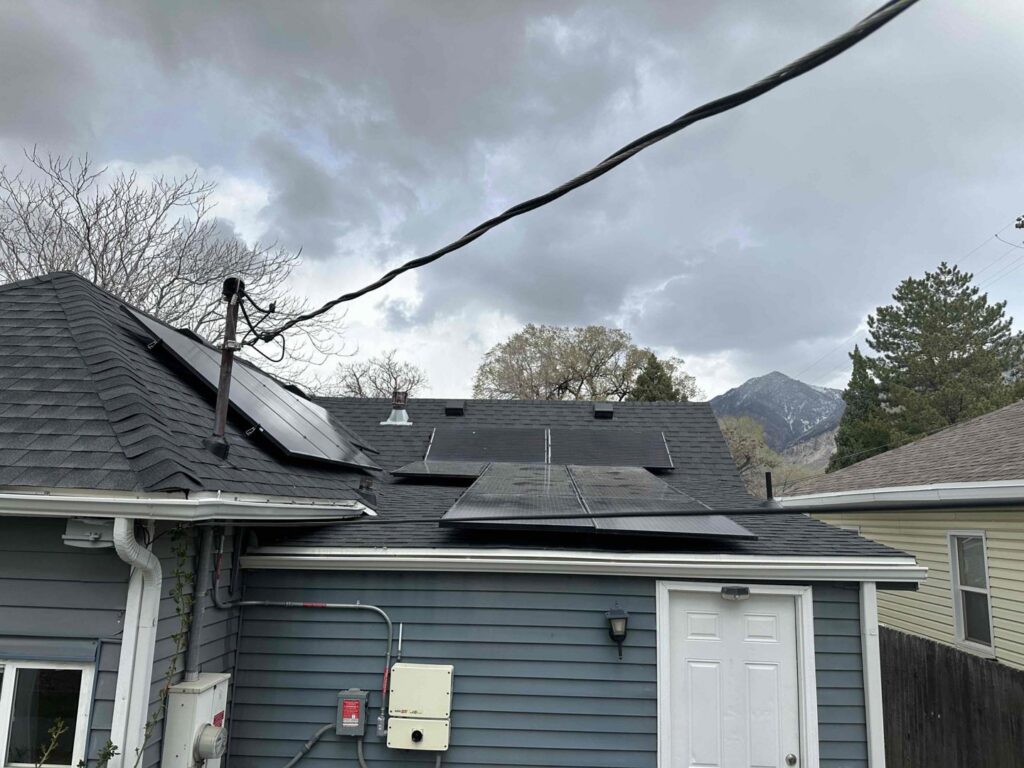 A residential home with solar panels installed on the roof by All Aboard Services in Farr West, UT.