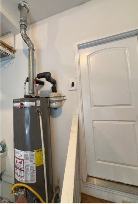 A residential water heater in a utility space serviced by Honesty Services in Rock Hill, SC.