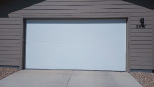 A newly installed white residential garage door by Front Range Raynor Garage Door & Service in Fort Collins, CO.