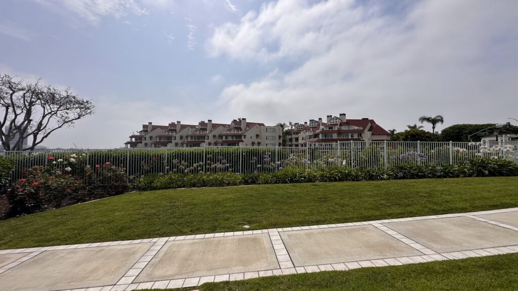 A residential white metal picket fence installed by San Diego Fencing Contractor A's Pro Build Fencing, enhancing a landscaped area in San Diego, CA.