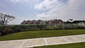 A residential white metal picket fence installed by San Diego Fencing Contractor A's Pro Build Fencing, enhancing a landscaped area in San Diego, CA.