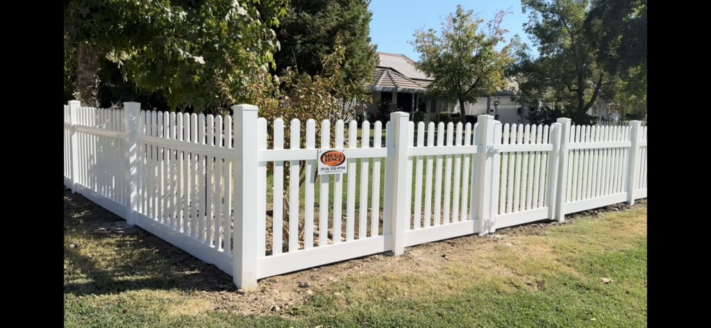 A charming white picket fence lining a residential street, showcasing quality work by Mega Fence in Thornton, CA.