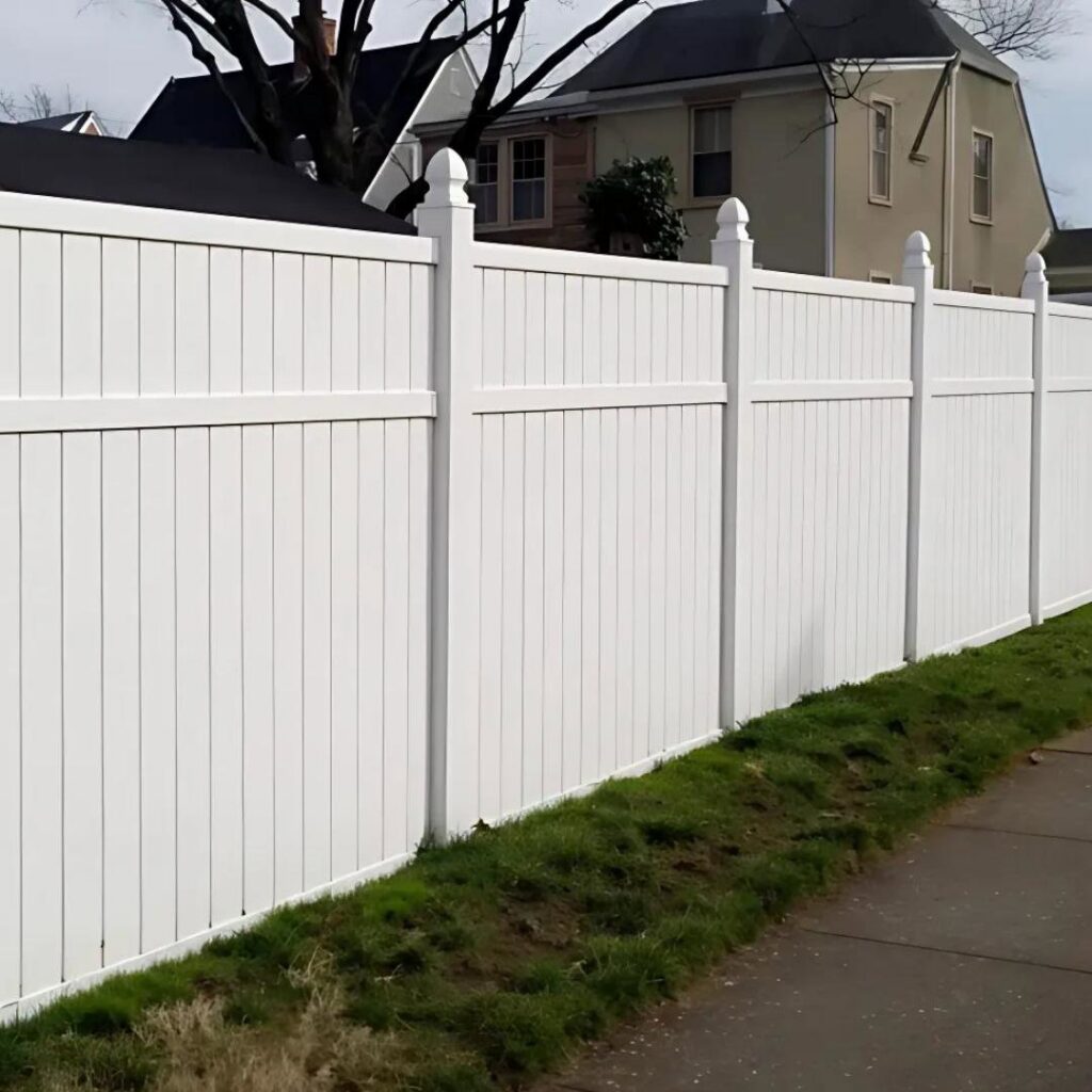 A long white vinyl fence installed along a residential sidewalk by Midwest Legacy Fence & Deck in Aurora, IL.