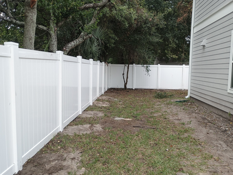 A completed residential white vinyl fence project by Geo's Custom Fencing, LLC, providing privacy in Jacksonville, FL.