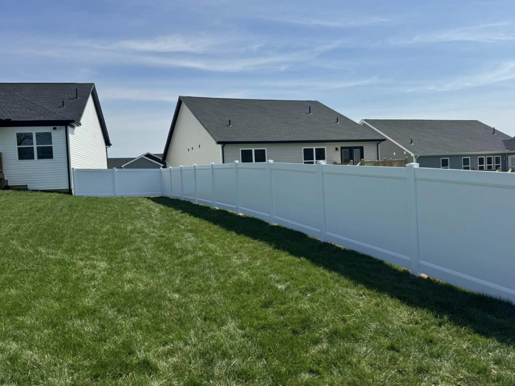 A white vinyl privacy fence installed in a residential backyard by KY Fencing Unlimited in Louisville, KY.