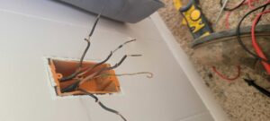 Exposed residential electrical wiring being installed in a wall box by PowerOn Electric llc in Solon, OH, with tools nearby.