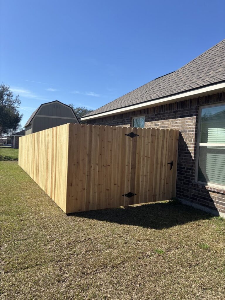 A new residential wood privacy fence with a matching gate, installed by 985 Fence, LLC in Schriever, LA.