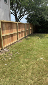 A long section of a newly installed wooden fence for a residential property by Alexi's Handyman Services in Indianapolis, IN.