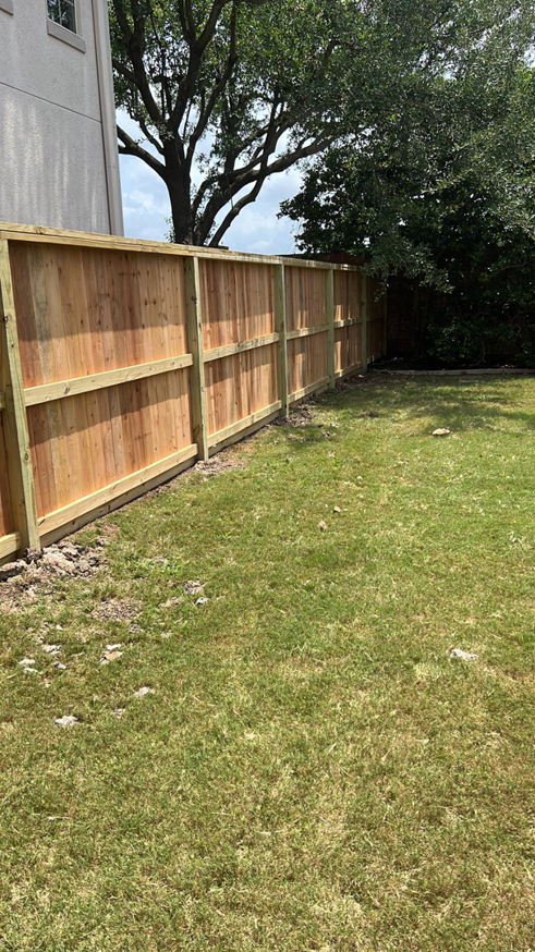 A long section of a newly installed wooden fence for a residential property by Alexi's Handyman Services in Indianapolis, IN.
