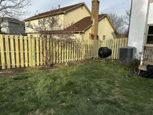 A new wood picket fence installed in a residential backyard by CDM Home Solutions in Columbus, OH.