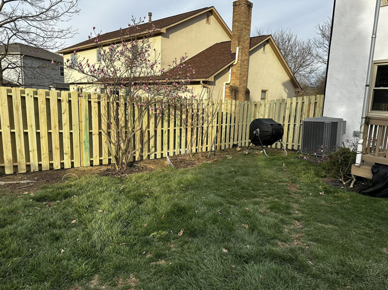 A new wood picket fence installed in a residential backyard by CDM Home Solutions in Columbus, OH.