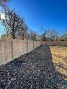 A newly installed light wood privacy fence in a residential setting by Axiom Fence LLC in Springfield, MO.