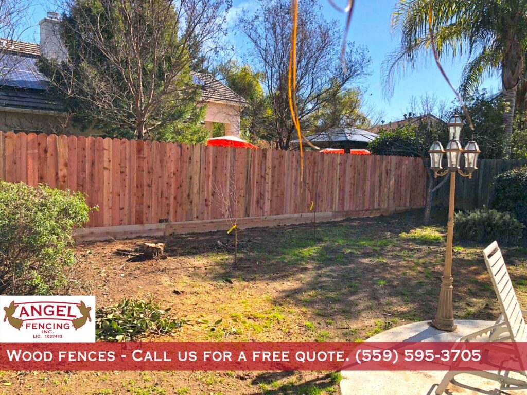 A residential wood privacy fence in a backyard installed by Angel Fencing Inc. in Fresno, CA