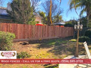 A residential wood privacy fence in a backyard installed by Angel Fencing Inc. in Fresno, CA