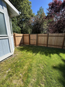 A residential wood privacy fence installation with a gate completed by FJ'S Fencing & Construction, LLC in Lake Oswego, OR.