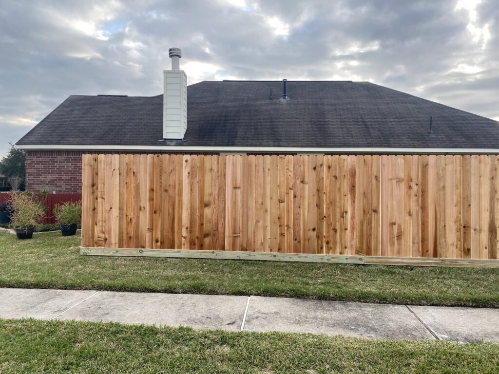 A residential wood privacy fence viewed from the street, installed by Wood Fence Houston in Houston, TX.