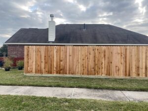 A residential wood privacy fence viewed from the street, installed by Wood Fence Houston in Houston, TX.