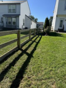 A wood fence with wire mesh installed between residential homes by ReliableFencing in Columbus, OH.