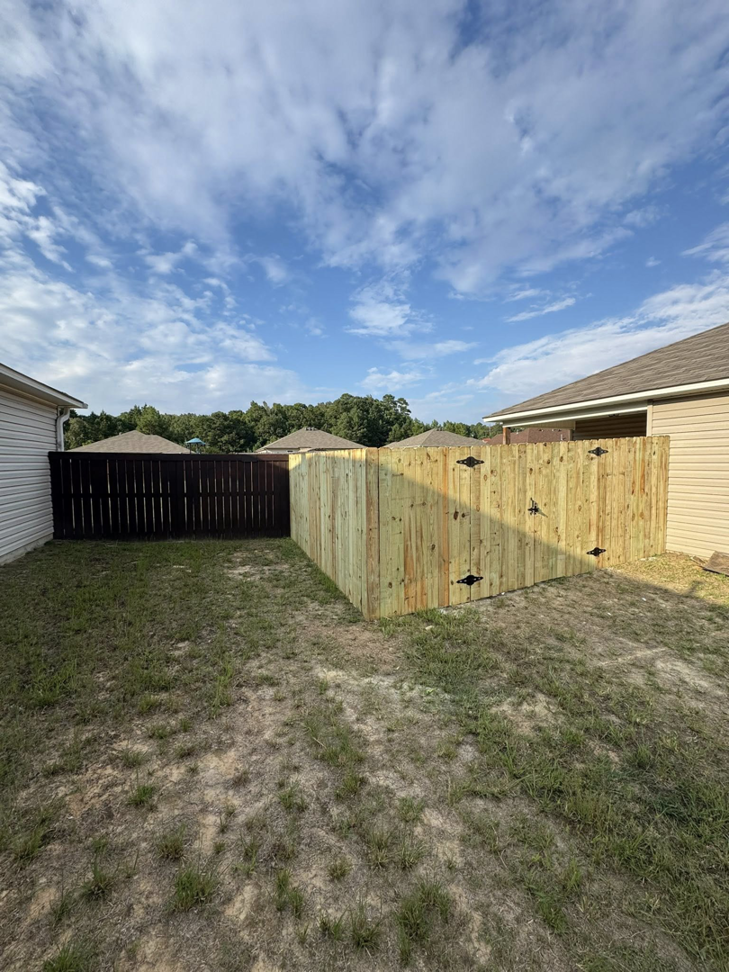 A corner section of a residential wooden privacy fence recently installed by Littleton Construction LLC in the Service Area.