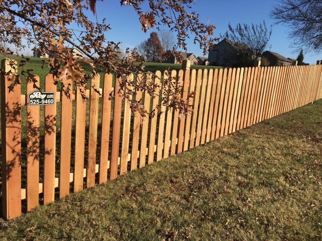 A newly installed residential wooden picket fence by Roy & Son Fencing in Lee's Summit, MO.