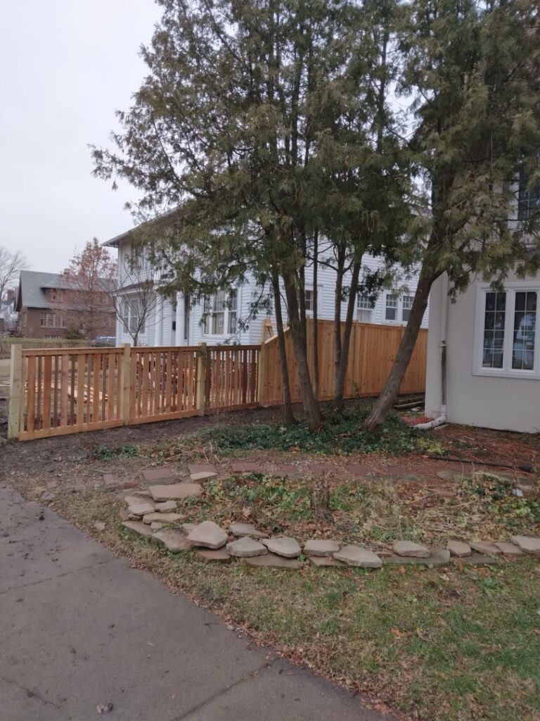 A new wooden picket fence installed in front of a residential property by Sparta Fencing in Ely, UK.