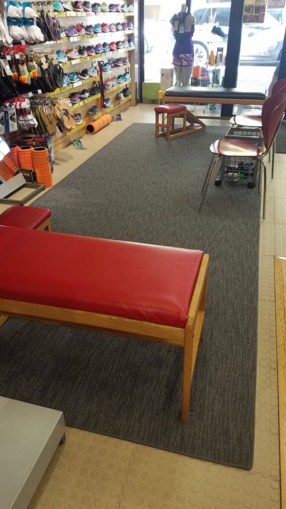 Grey carpet runners installed in a retail shoe store by Palmetto Carpet Company in Miami, FL.
